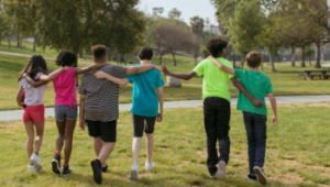 children walking in park with arms around each other